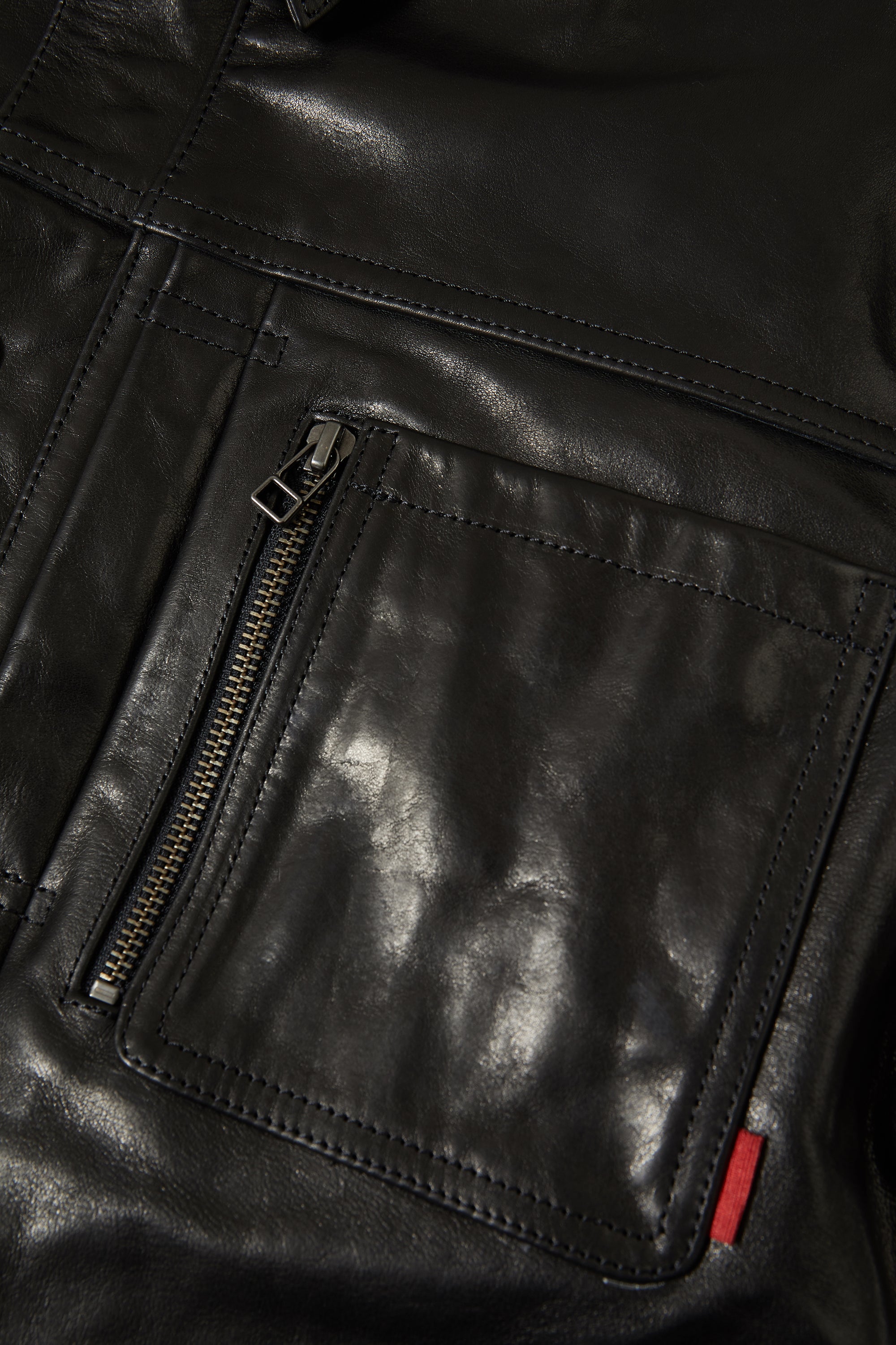 Double front pleats and rear yoke detail on the 001.LEATHER.JACKET