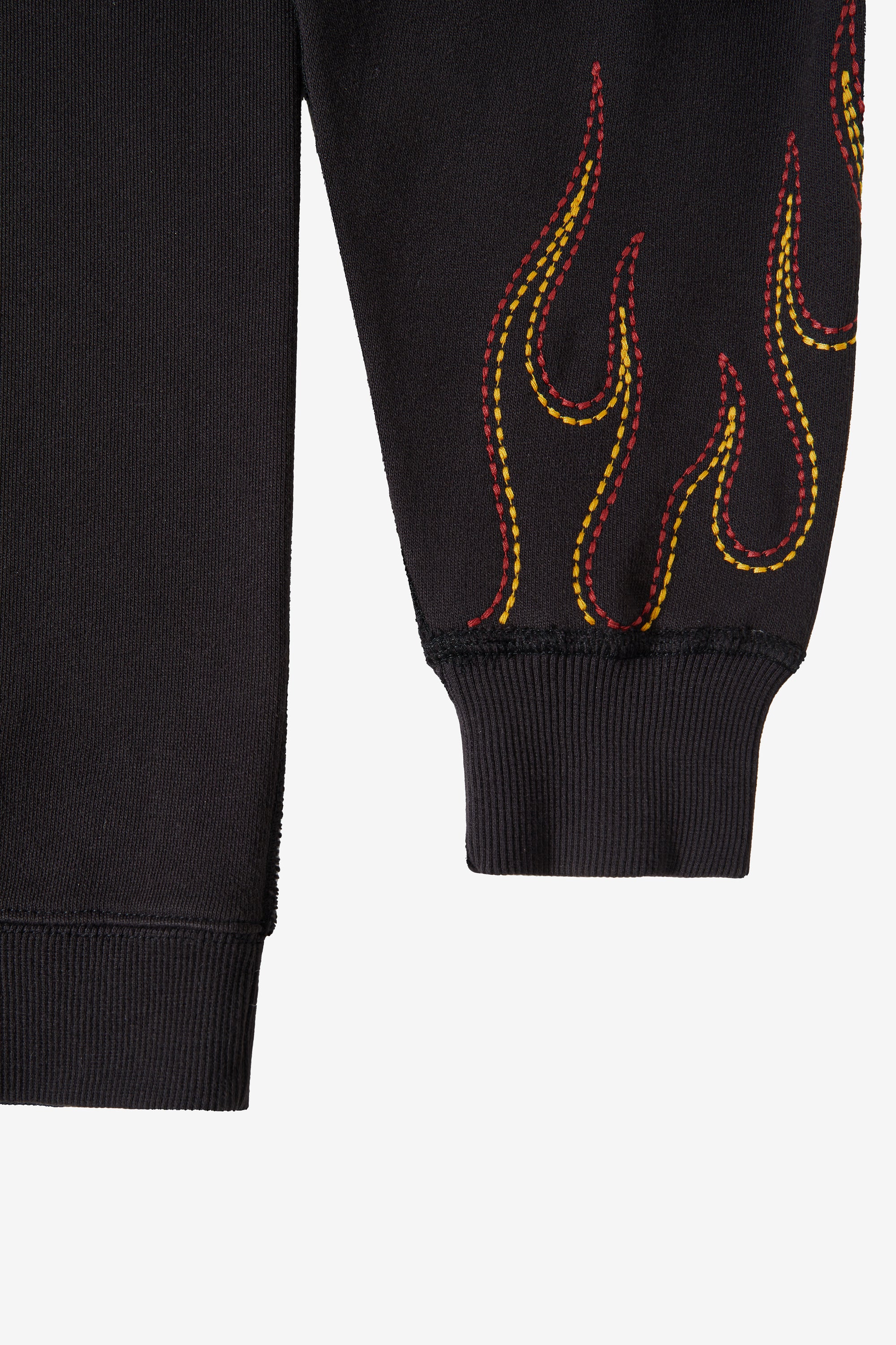 Exposed chain topstitching through the raglan seams of the FLAME.CREW